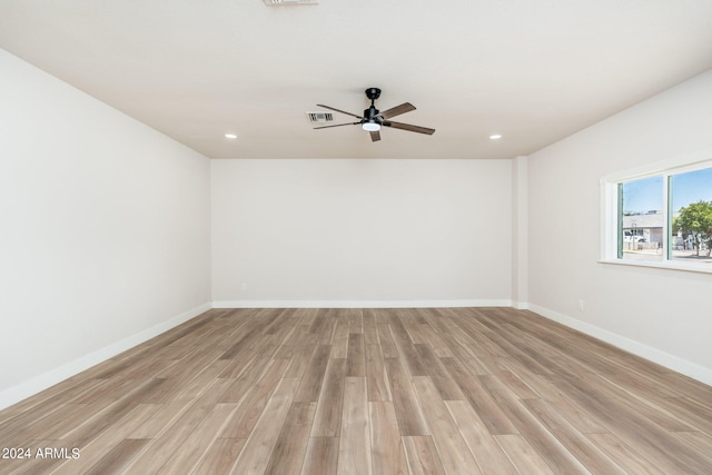 spare room with ceiling fan and light wood-type flooring