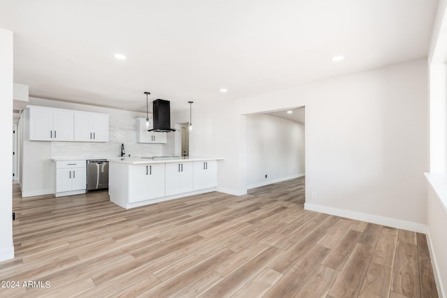 kitchen featuring white cabinets, dishwasher, a kitchen island, hanging light fixtures, and range hood