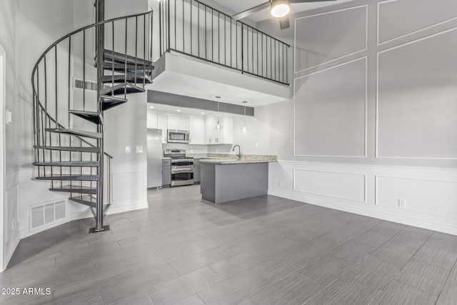 interior space with ceiling fan and sink