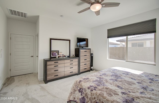 bedroom featuring ceiling fan and light carpet