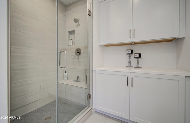 bathroom featuring tile patterned floors and a shower with door