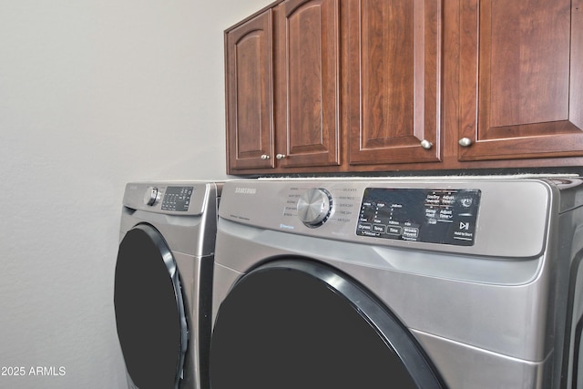 laundry area with cabinet space and washer and dryer