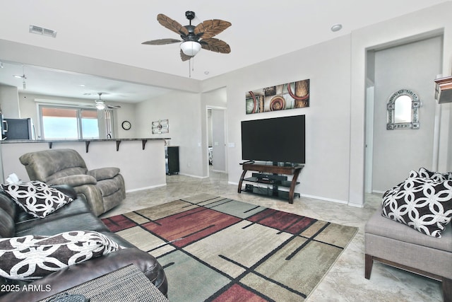 living room featuring visible vents, baseboards, and ceiling fan