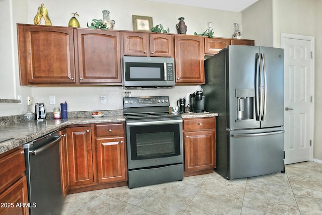 kitchen with light tile patterned floors and stainless steel appliances