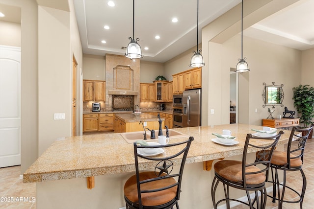 12976 W Plum Rd, Peoria, AZ 85383 - kitchen with appliances with stainless steel finishes, tile counters, a raised ceiling, a spacious island, and recessed lighting