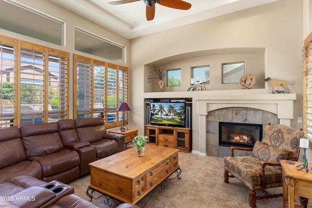 12976 W Plum Rd, Peoria, AZ 85383 - tiled living room with a ceiling fan and a fireplace