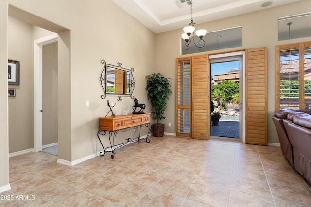 12976 W Plum Rd, Peoria, AZ 85383 - tiled foyer entrance featuring a raised ceiling, a chandelier, visible vents, and baseboards