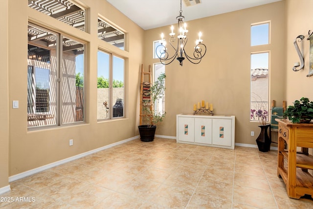 12976 W Plum Rd, Peoria, AZ 85383 - dining space featuring tile patterned flooring, a chandelier, and baseboards