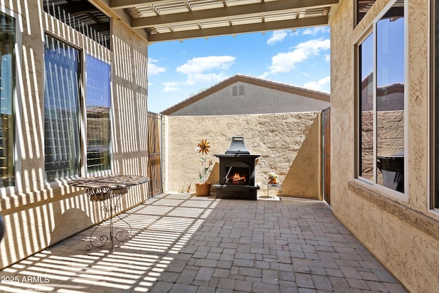 12976 W Plum Rd, Peoria, AZ 85383 - view of patio / terrace with a lit fireplace