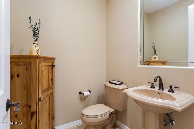 12976 W Plum Rd, Peoria, AZ 85383 - bathroom featuring baseboards, toilet, and a sink