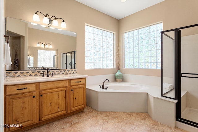 12976 W Plum Rd, Peoria, AZ 85383 - bathroom featuring decorative backsplash, vanity, a bath, tile patterned floors, and a stall shower