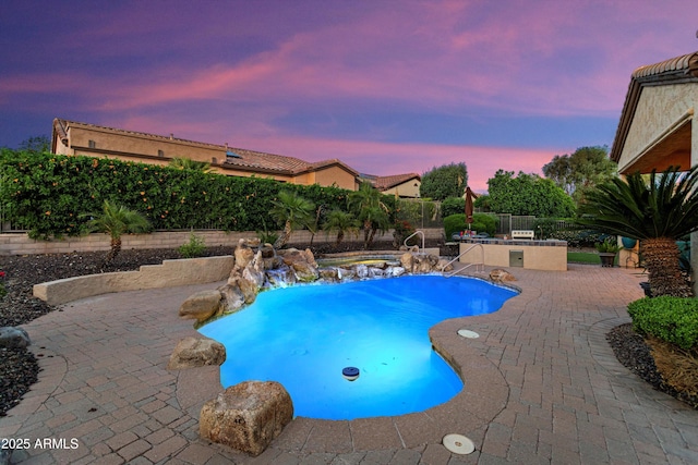 12976 W Plum Rd, Peoria, AZ 85383 - pool at dusk featuring a fenced backyard, a fenced in pool, and a patio area