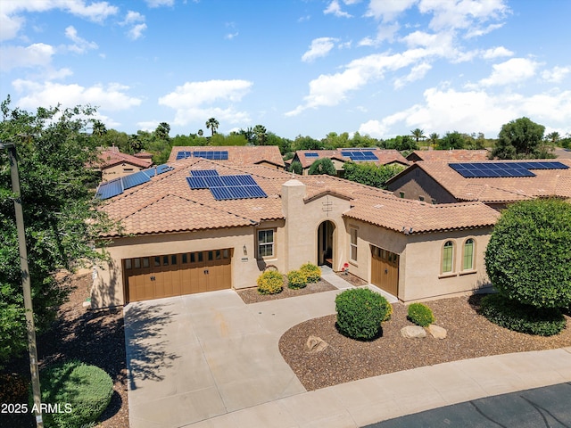 12976 W Plum Rd, Peoria, AZ 85383 - mediterranean / spanish house featuring a tile roof, a garage, driveway, roof mounted solar panels, and stucco siding