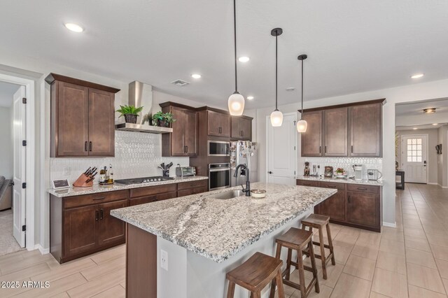 4514 W Hazel Ln, San Tan Valley, AZ 85144 - kitchen with wall chimney range hood, appliances with stainless steel finishes, a sink, tasteful backsplash, and dark brown cabinetry