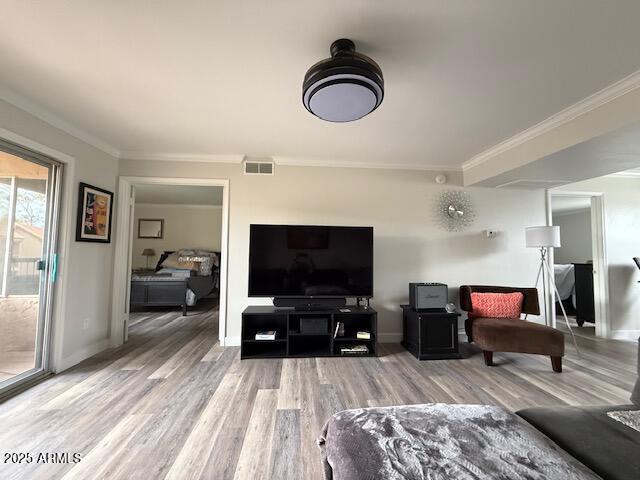 living room featuring ornamental molding and hardwood / wood-style floors