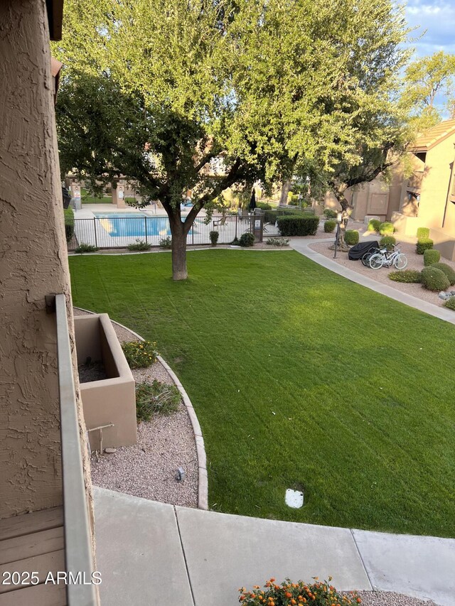 view of yard featuring a fenced in pool