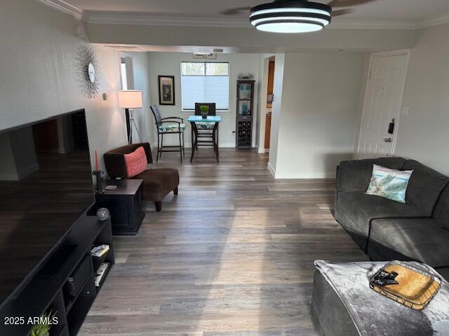 living room with crown molding and dark hardwood / wood-style flooring