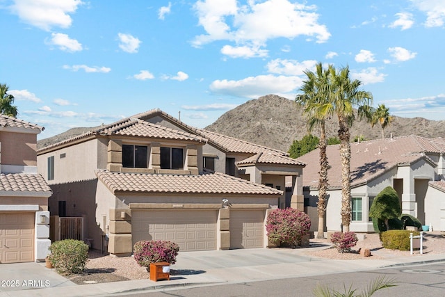 view of front of property featuring a garage and a mountain view