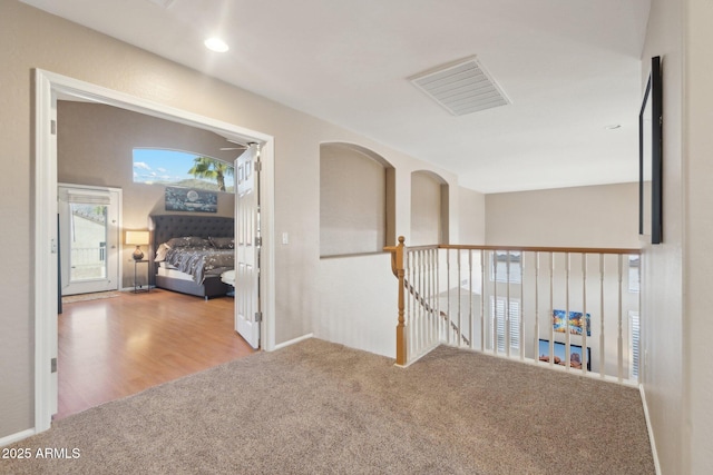 hall featuring light colored carpet