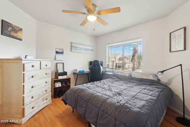 bedroom with light hardwood / wood-style flooring and ceiling fan