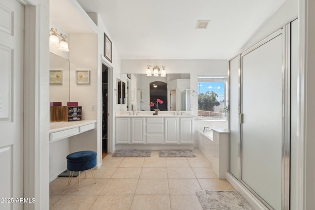 bathroom featuring tile patterned flooring, plus walk in shower, and vanity