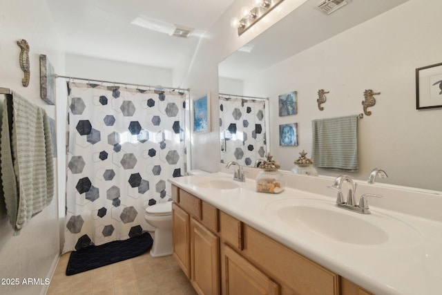 bathroom with a shower with curtain, vanity, tile patterned flooring, and toilet