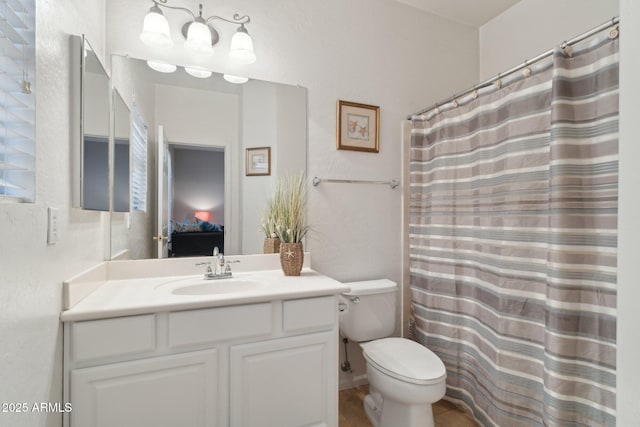 bathroom featuring a shower with curtain, vanity, and toilet