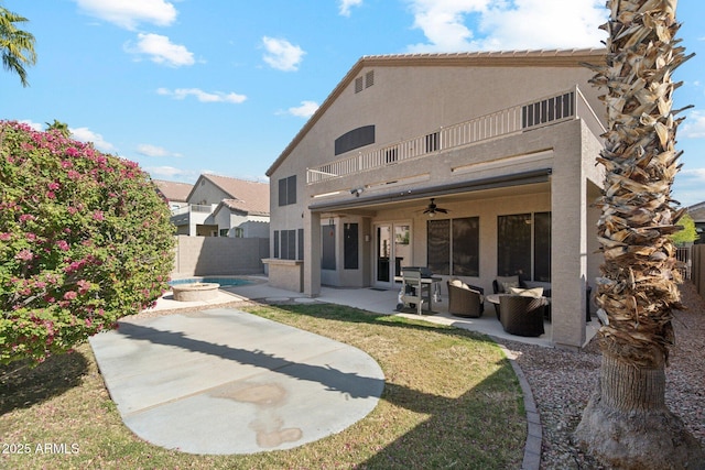 back of house featuring a patio, a balcony, an in ground hot tub, an outdoor hangout area, and ceiling fan