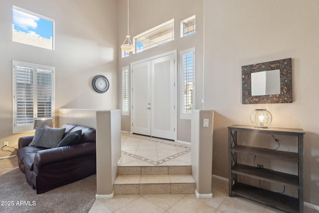 tiled entrance foyer with a towering ceiling