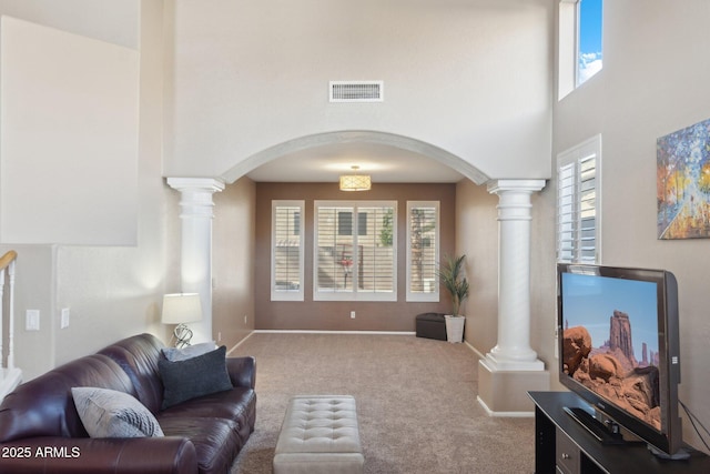 carpeted living room featuring decorative columns