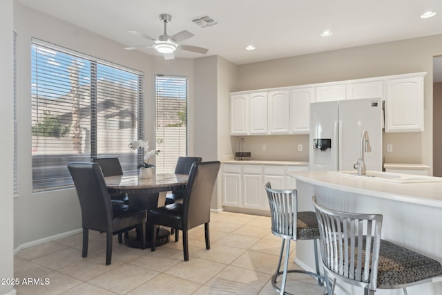 tiled dining room featuring ceiling fan