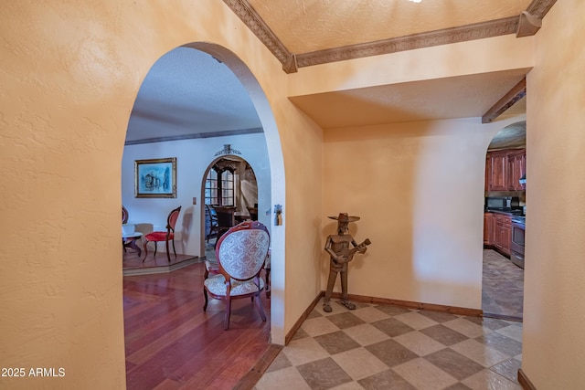 hallway featuring ornamental molding and a textured ceiling