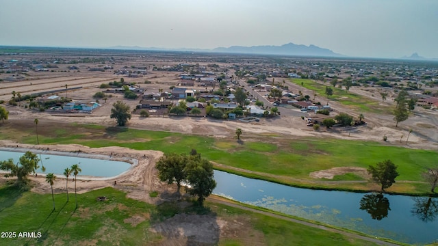 birds eye view of property with a water and mountain view