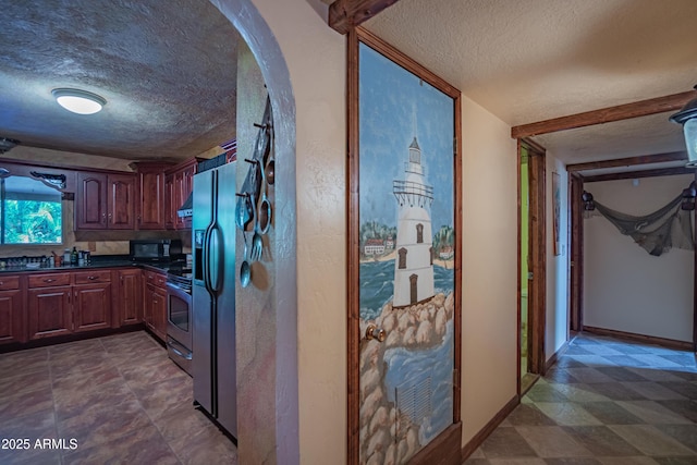 kitchen featuring stainless steel appliances and a textured ceiling