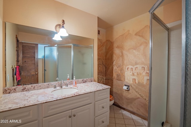 bathroom with vanity, toilet, a shower with shower door, and tile patterned flooring