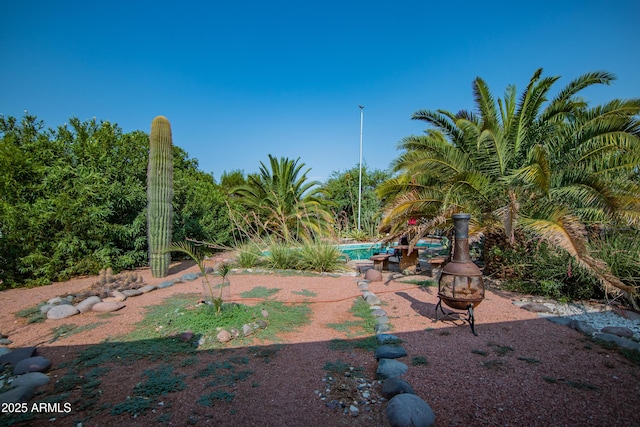 view of yard with an outdoor fire pit