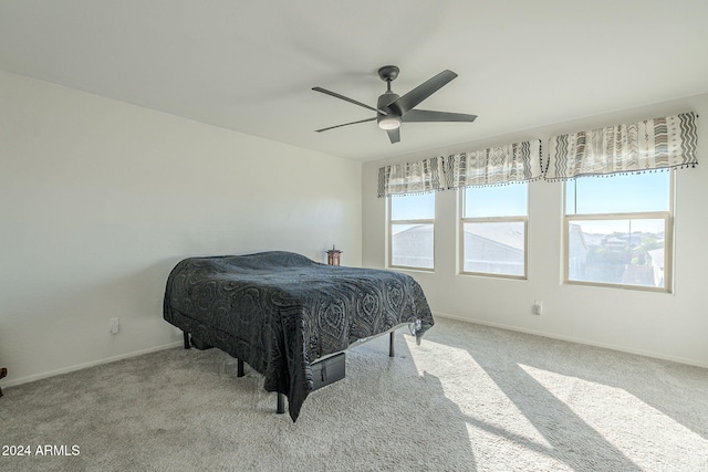 carpeted bedroom with multiple windows and ceiling fan