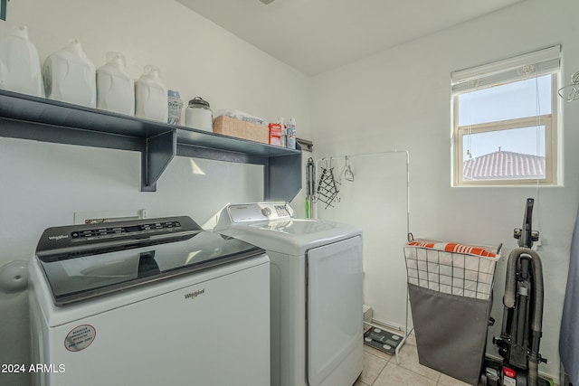 laundry area with washing machine and dryer and light tile patterned flooring