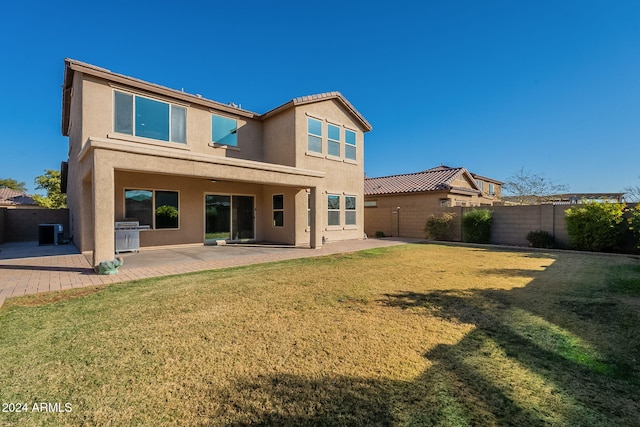 back of house with a yard, cooling unit, and a patio area