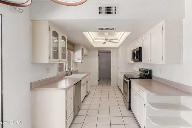 kitchen with a sink, light tile patterned floors, stainless steel appliances, and visible vents