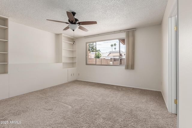 unfurnished room with a ceiling fan, a textured ceiling, and carpet flooring