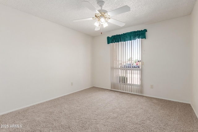 carpeted empty room with baseboards, a ceiling fan, and a textured ceiling