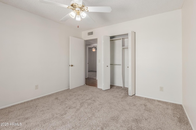 unfurnished bedroom featuring ceiling fan, visible vents, baseboards, and carpet