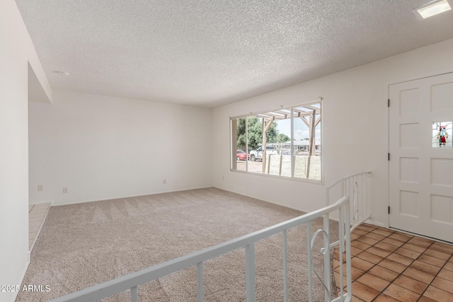 carpeted entryway with a textured ceiling
