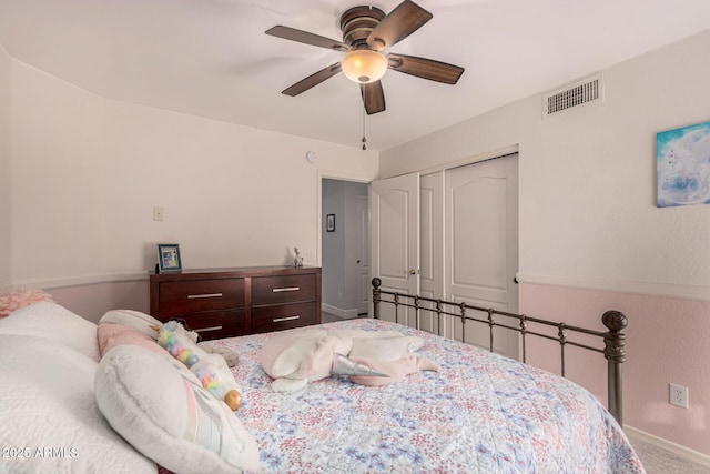 carpeted bedroom featuring ceiling fan and a closet