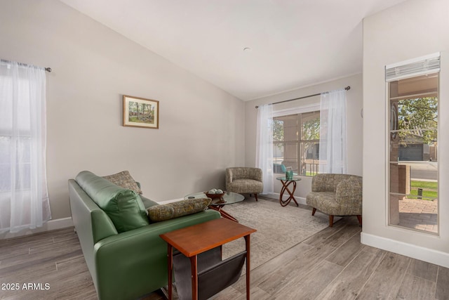 sitting room featuring lofted ceiling and a healthy amount of sunlight