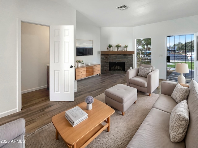 living room with a fireplace and dark hardwood / wood-style flooring