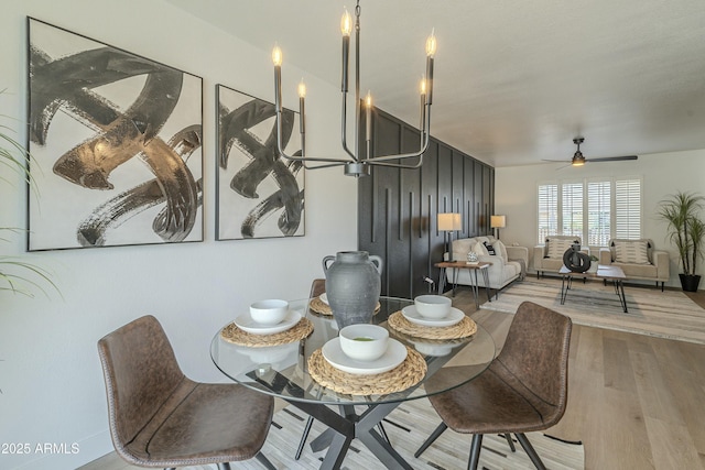 dining space featuring wood-type flooring and ceiling fan