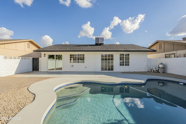 view of swimming pool featuring cooling unit and a patio area