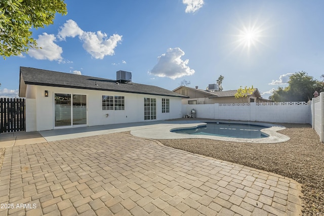 view of pool with cooling unit and a patio area